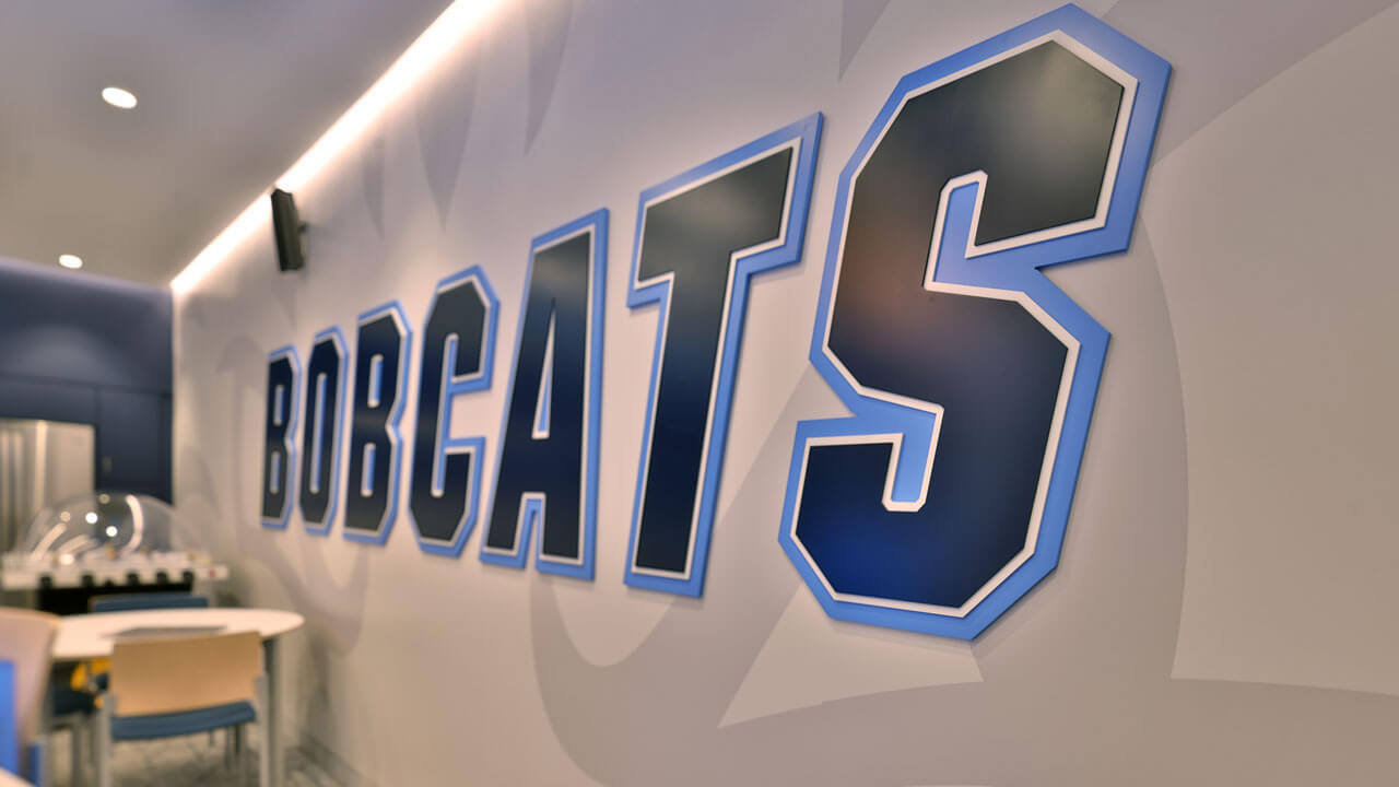 Close-up of the word Bobcats on the wall of the women's ice hockey locker room.