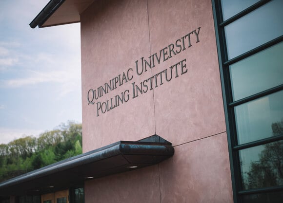 Closeup of the Quinnipiac University Polling Institute building and sign