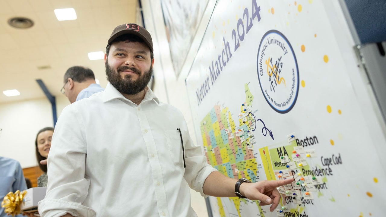 Student places pin on the Quinnipiac Class of 2024 Match Day board