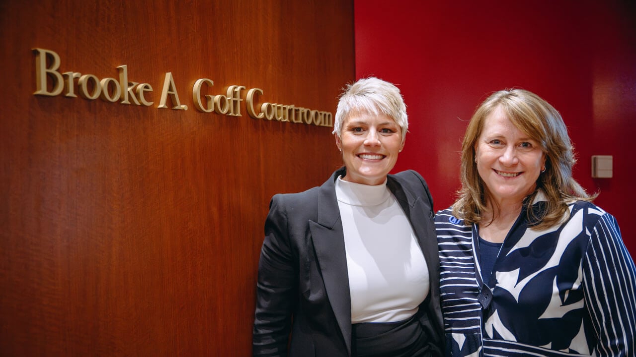 Brooke A. Goff and School of Law Dean Jennifer Brown stand in front of newly dedicated sign that reads Brooke A. Goff Courtroom