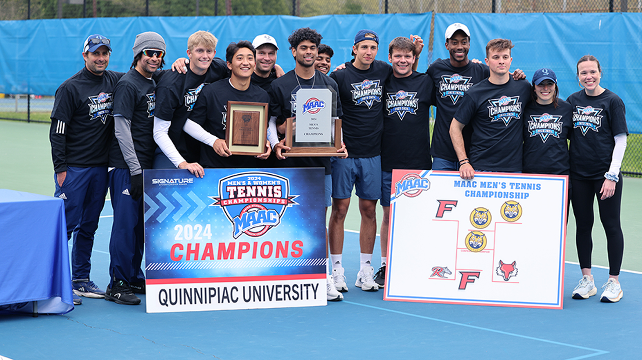 The men's tennis team poses and smiles arm in arm after winning the MAAC 2024 championship