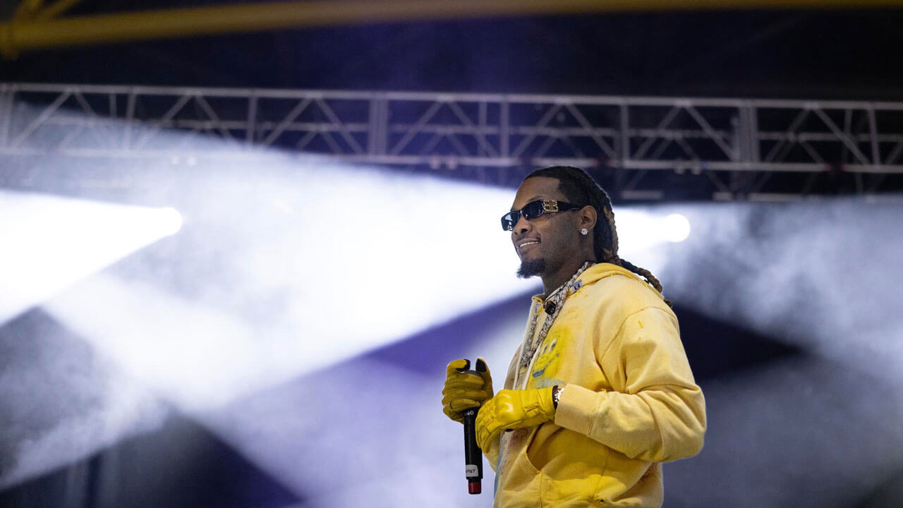 Offset in yellow sweatshirt on stage during Wake the Giant