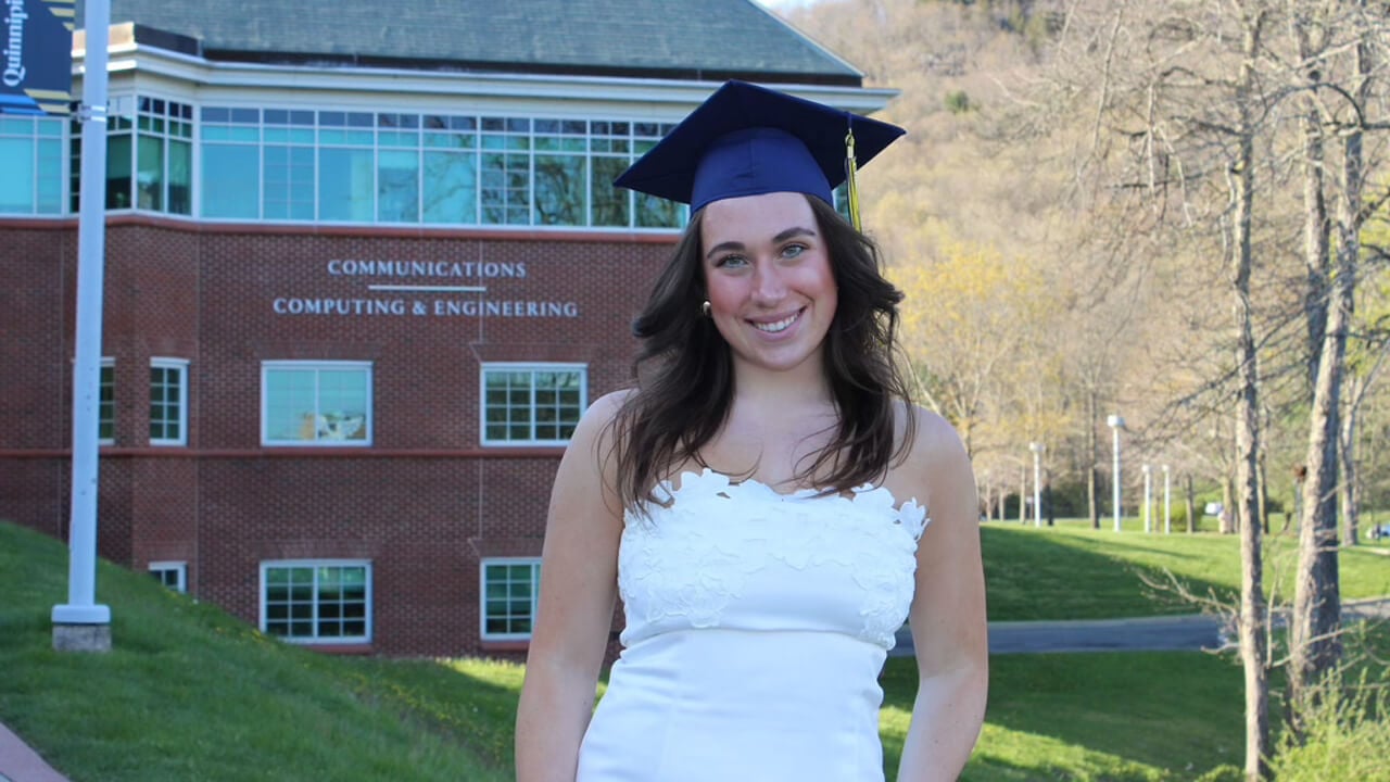 Madison Fahlborg poses with graduation cap on her head