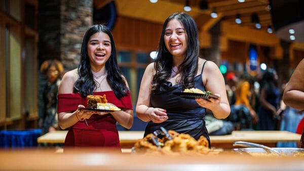 Two students serve themselves food at the On the Rocks Pub and Grille