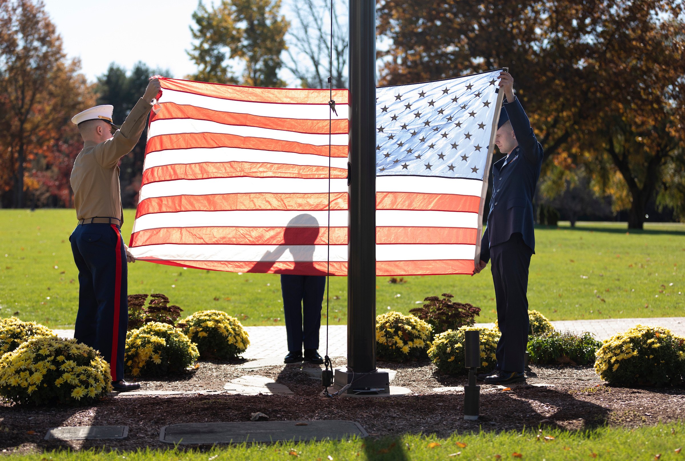 Two men folding the American flag