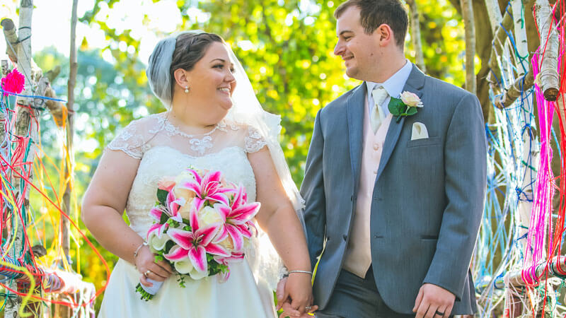Kristin Spath and Craig Gordon hold hands and walk down the aisle at their wedding