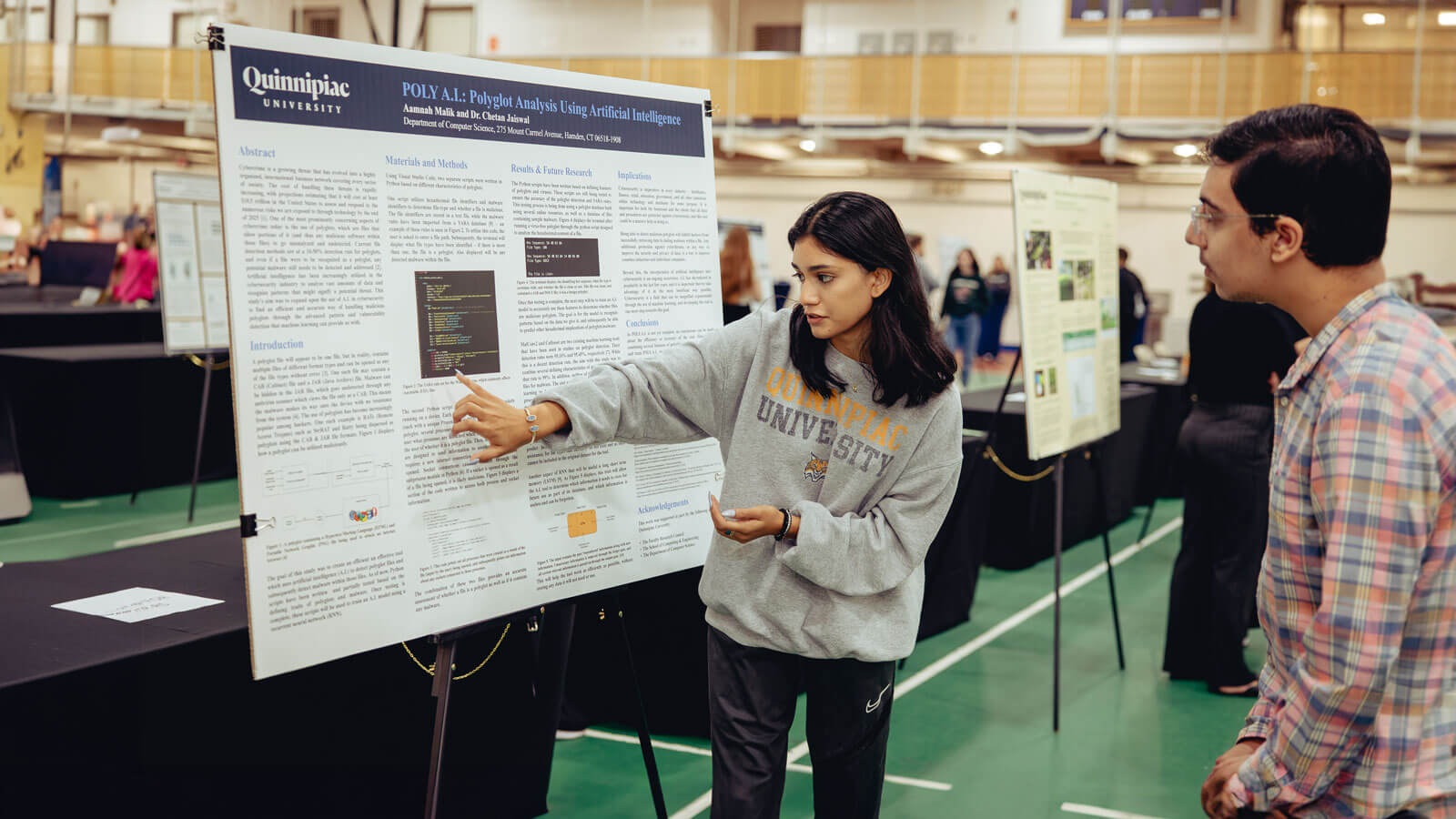A student presents her project to an exploratorium attendee during Bobcat Weekend.