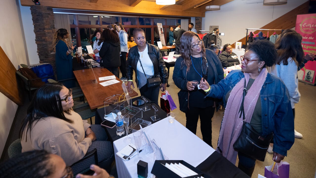 Dozens of business owners and shoppers mingle a the sip and shop event