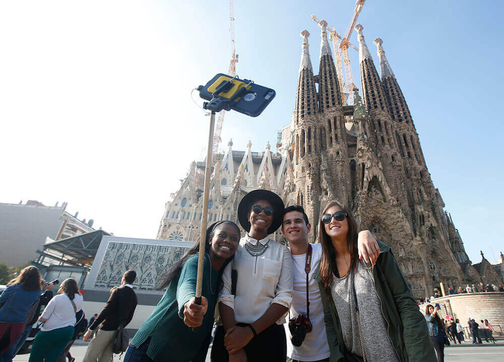 Quinnipiac students pose to take a selfie in front of the Basilica Sagrada Familia in Bareclona