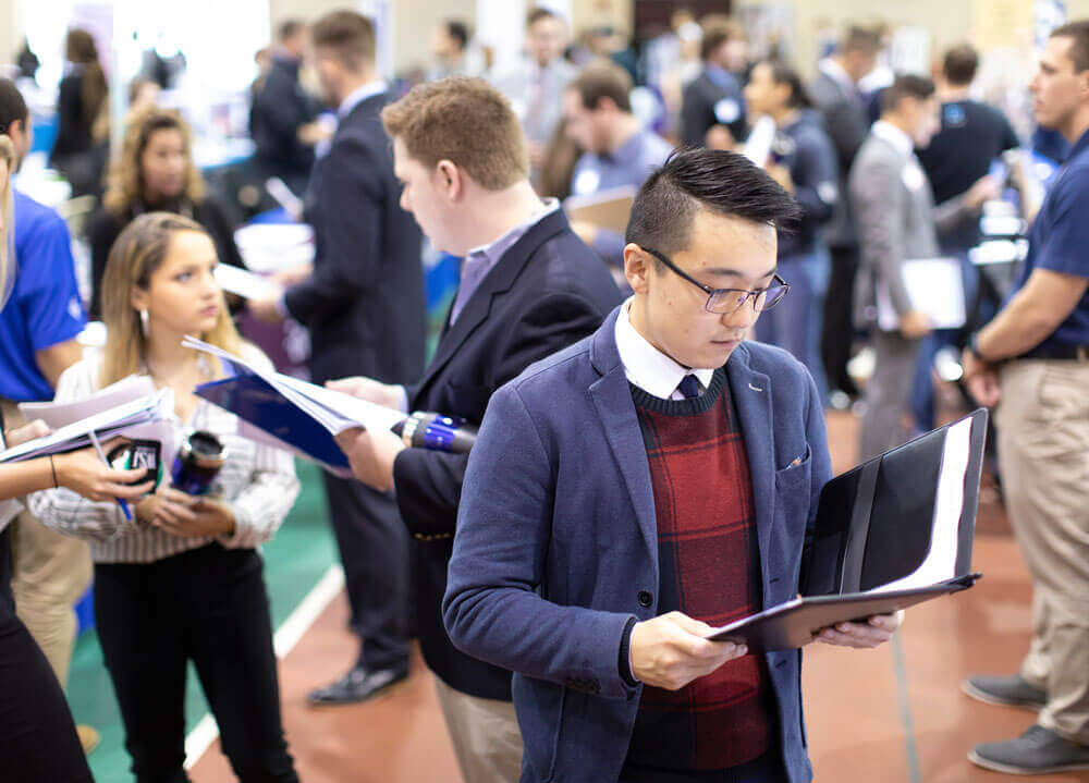 A group of students attend a job fair