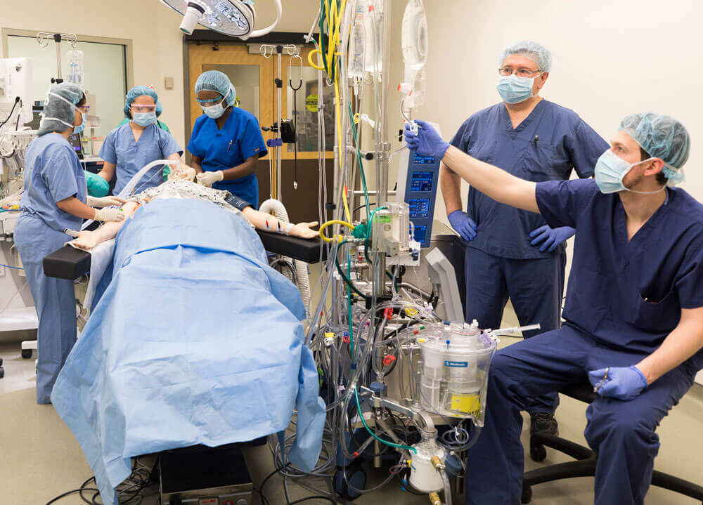A group of students and the professor work in an operating room