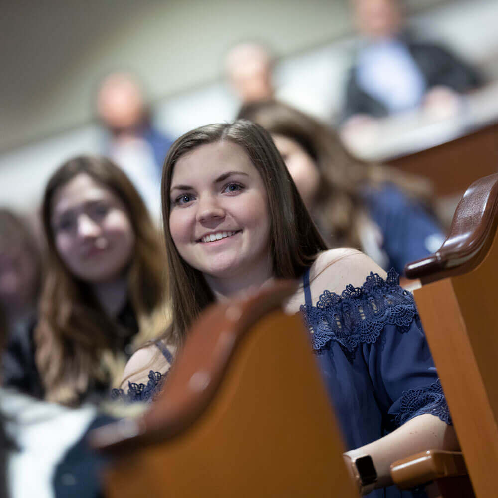A prospective student listens during an information session