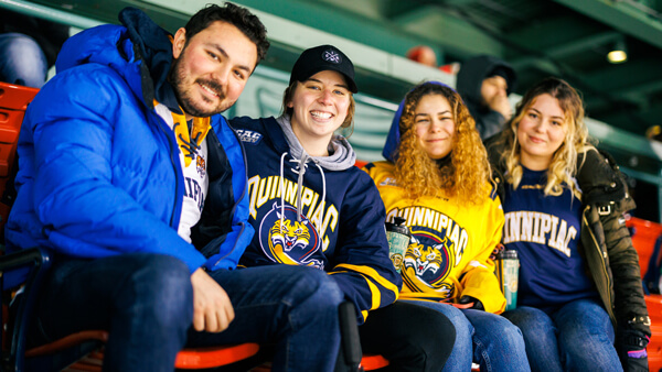 Student hockey fans watching a game.