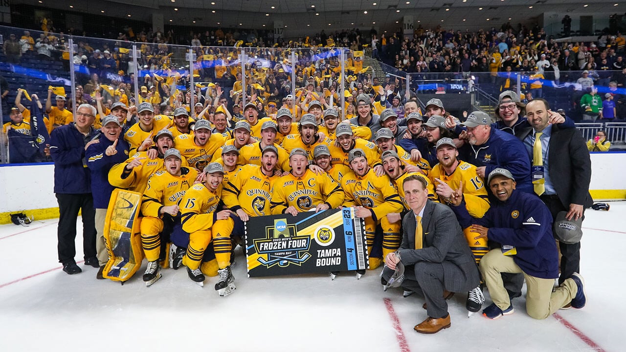 Men's Ice Hockey poses with a Frozen Four poster after defeating Ohio State in Bridgeport