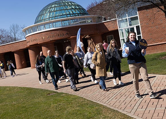 Admitted student take a tour of campus with a guide