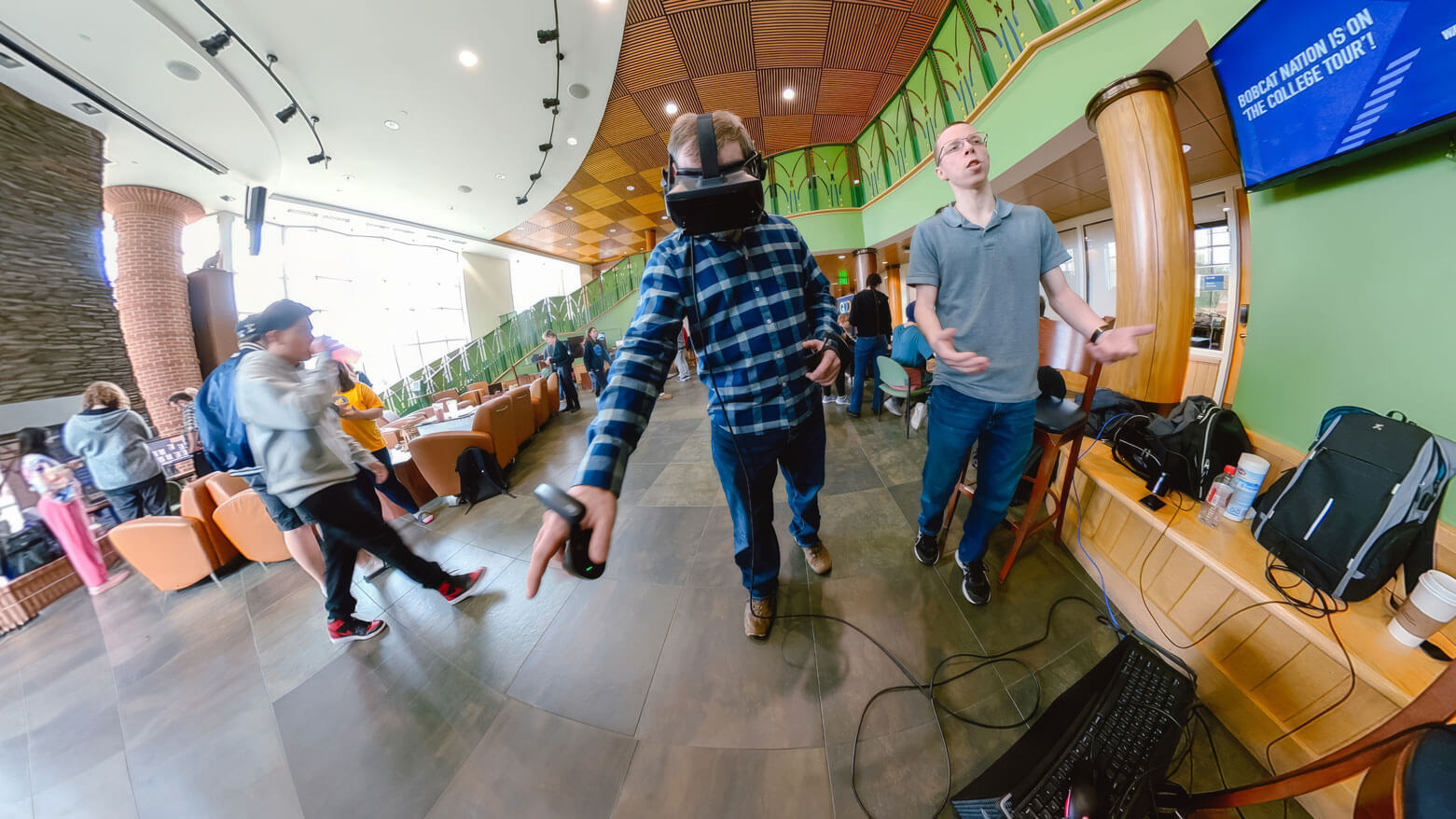 Student and professor play a virtual reality game.