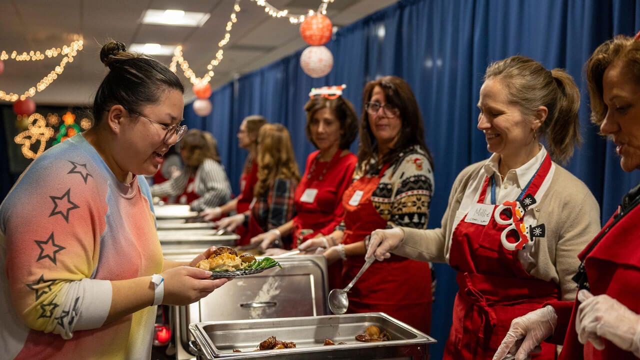 Graduate Quinnipiac professors serve students food in North Haven Cafe