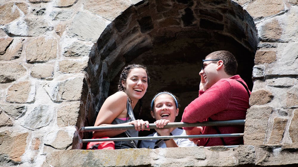 Quinnipiac medical students Marisa Goshorn and Kat Chinnici and Cheshire transitional student Brent Bouteiller look out from the castle at Sleeping Giant State Park on Thursday, June 2, 2016 as part of an interprofessional service learning course. The popular Sleeping Giant Tower Trail offers a 3-mile out and back path that offers scenic views of the Mount Carmel Campus.