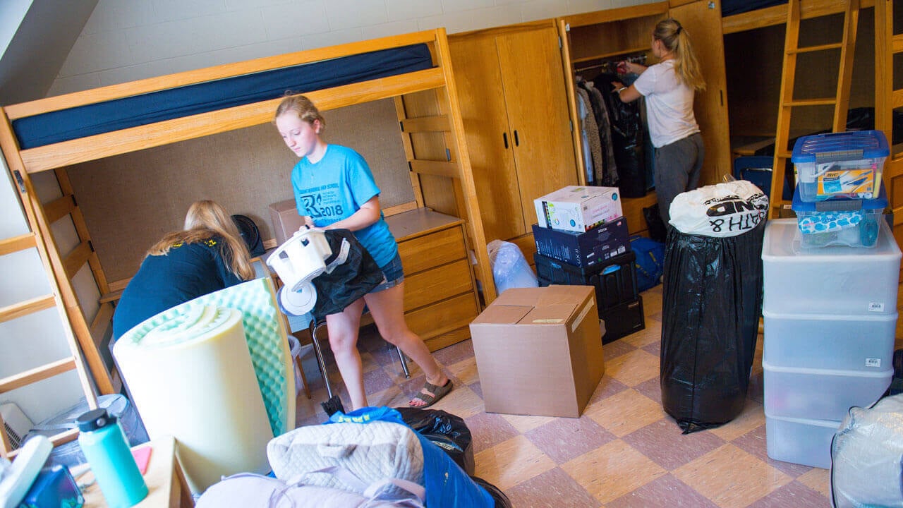 A student unpacking in their room