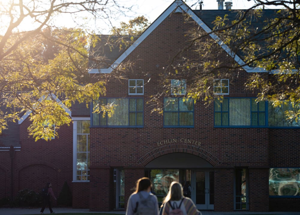 A view of Echlin Center surrounded by fall light and leaves